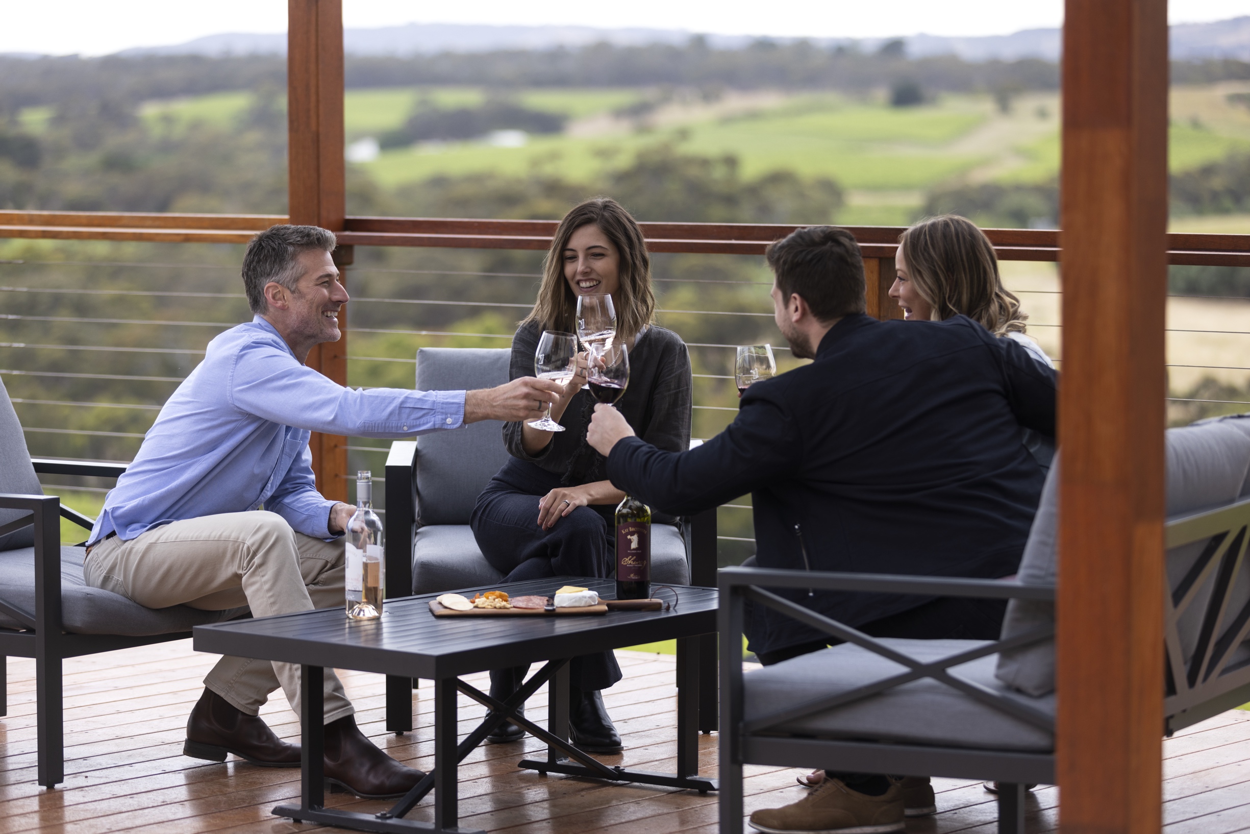 People sitting outside drinking wine